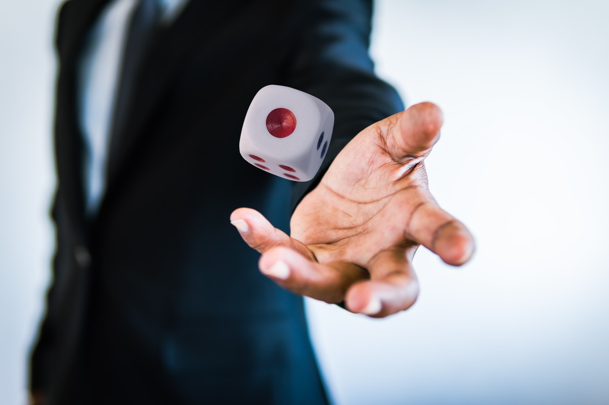 Business man throwing the dice gambling game in hand concept