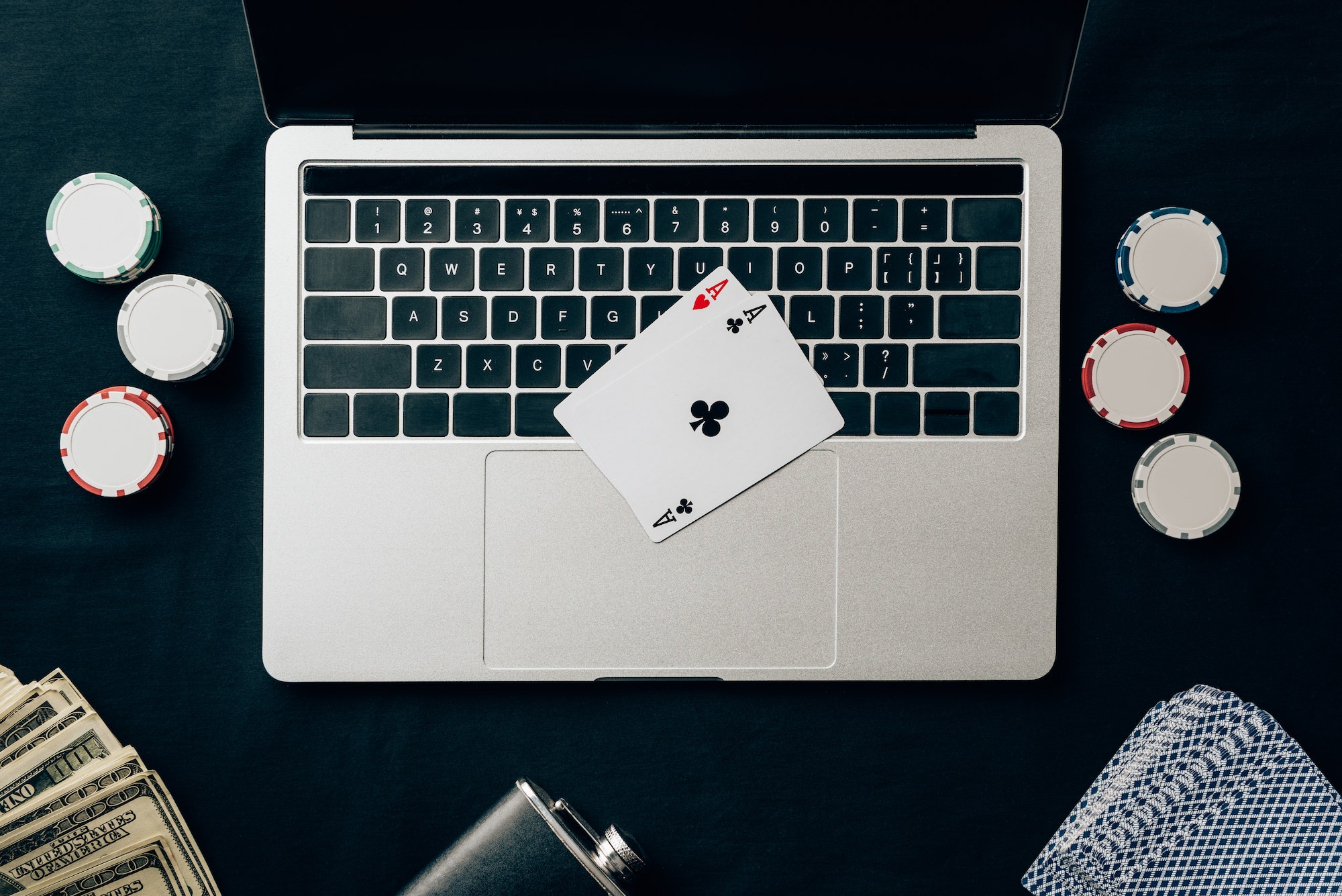 Online gambling concept with chips and money on laptop